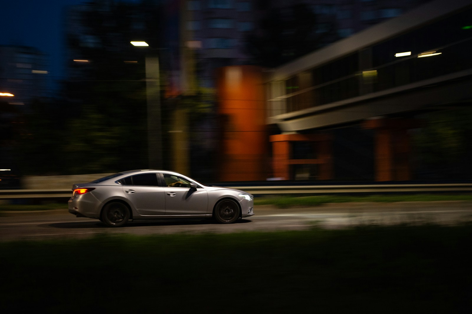 A car driving down a street at night
